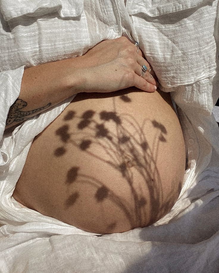 a pregnant woman's shadow on her belly