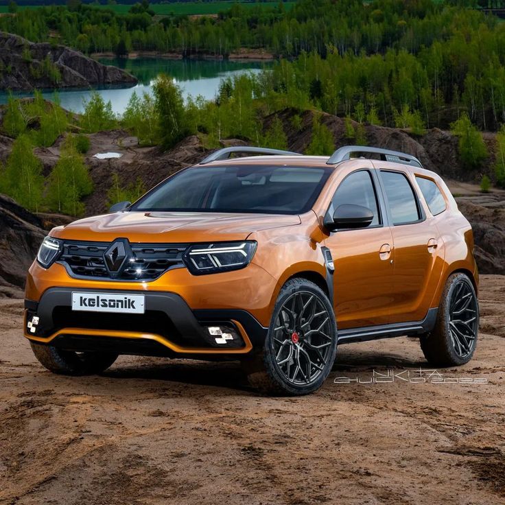 an orange car parked on top of a dirt field