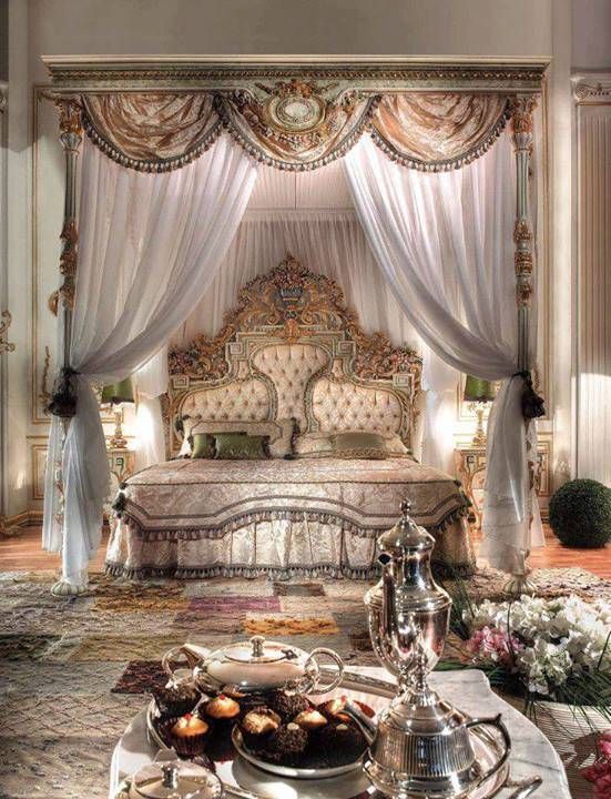 a fancy bedroom with an ornate bed and canopy