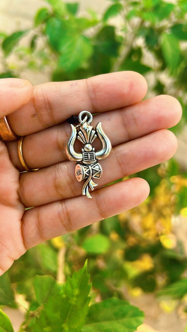 This bold and beautiful Shiva Trident pendant comes. This is a beautiful way to celebrate your divine masculine energy whatever your gender, and is a beautiful gift for adorning your masculine beloved. See below for more information about this potent, tantric symbol and its meaning. Meaning of the Shiva Trident symbol: Shiva is ultimate representation of the divine masculine in Hindu cosmology and yogic philosophy. He is the deity of destruction and transformation, and represents pure formless c Shiva Jewellery, Hindu Jewelry, Friendship Day Gifts, Shiva Shakti, Minimal Jewelry, Silver Art, Lord Shiva, Religious Jewelry, Shiva