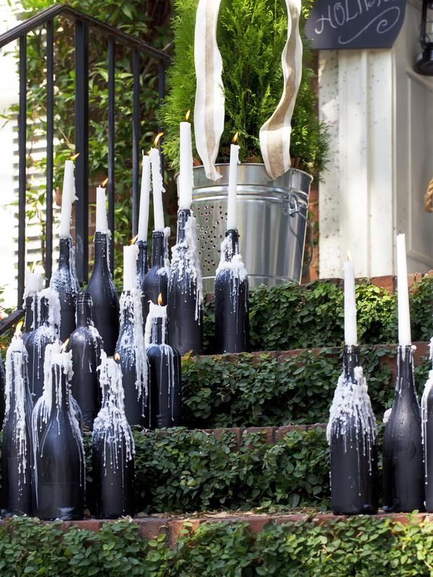 a bunch of wine bottles that are sitting on the ground in front of some bushes