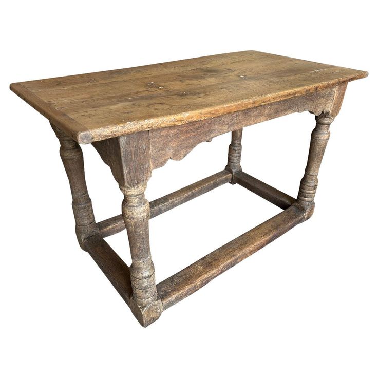 an old wooden table with turned legs