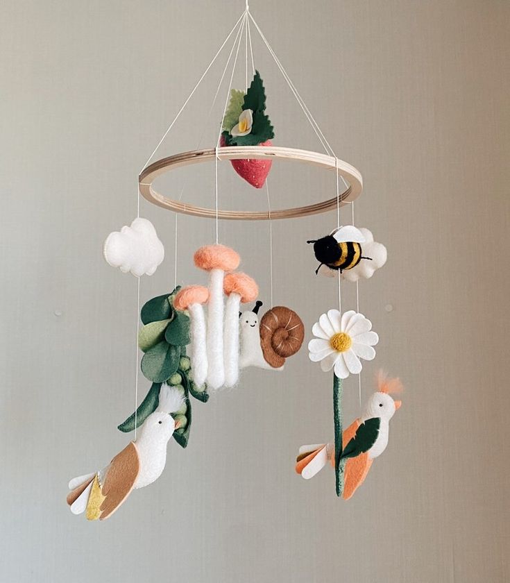 a mobile with animals and flowers hanging from it