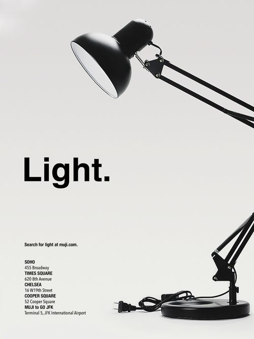 a black and white photo of a desk lamp with the word light on it's side