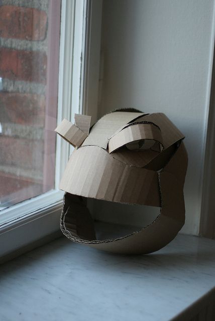 a cardboard helmet sitting on top of a window sill