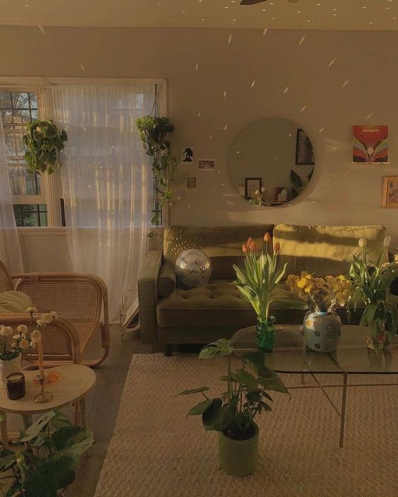 a living room filled with furniture and plants