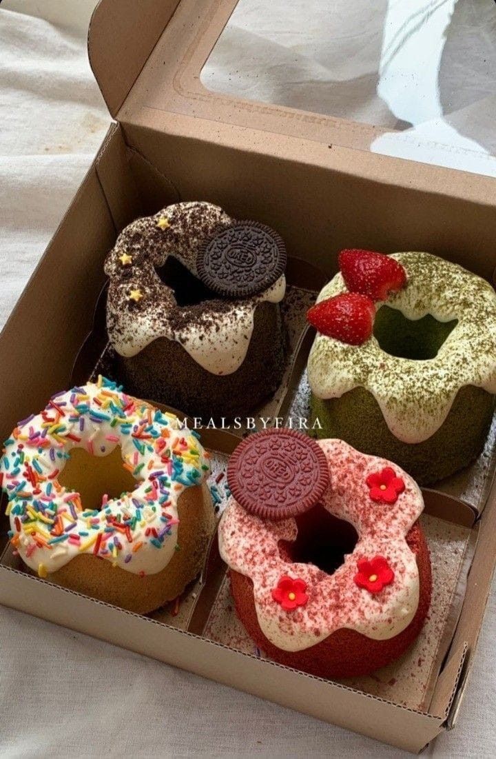 four different types of donuts in a box