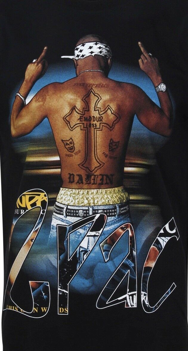 the back of a man's shirt with tattoos on his chest and hands behind him