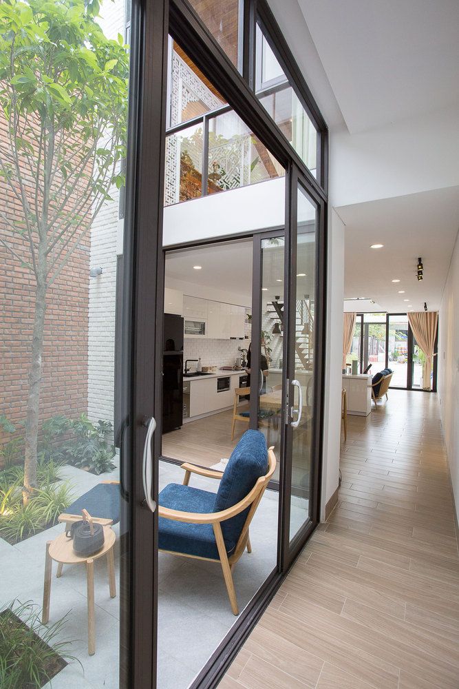 an open living room and dining area with sliding glass doors