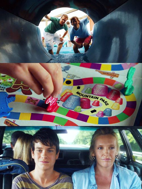 two people are sitting in the back seat of a car and one person is pointing at a board game