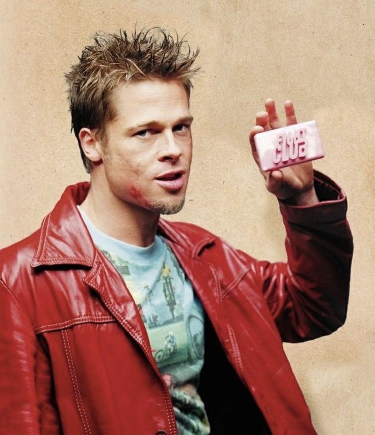 a man in a red leather jacket holding up a cell phone