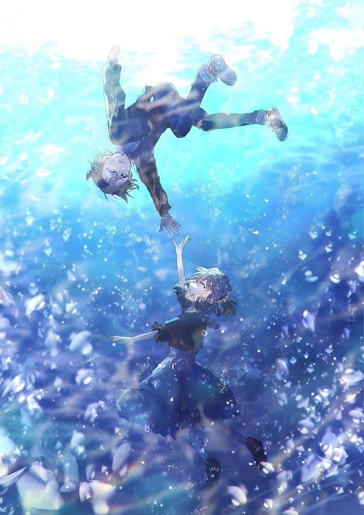 two people diving in the ocean with bubbles all around them and one person is upside down