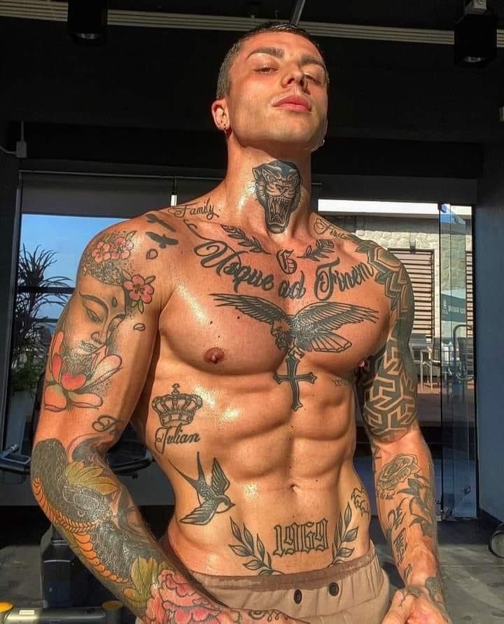 a man with lots of tattoos on his chest