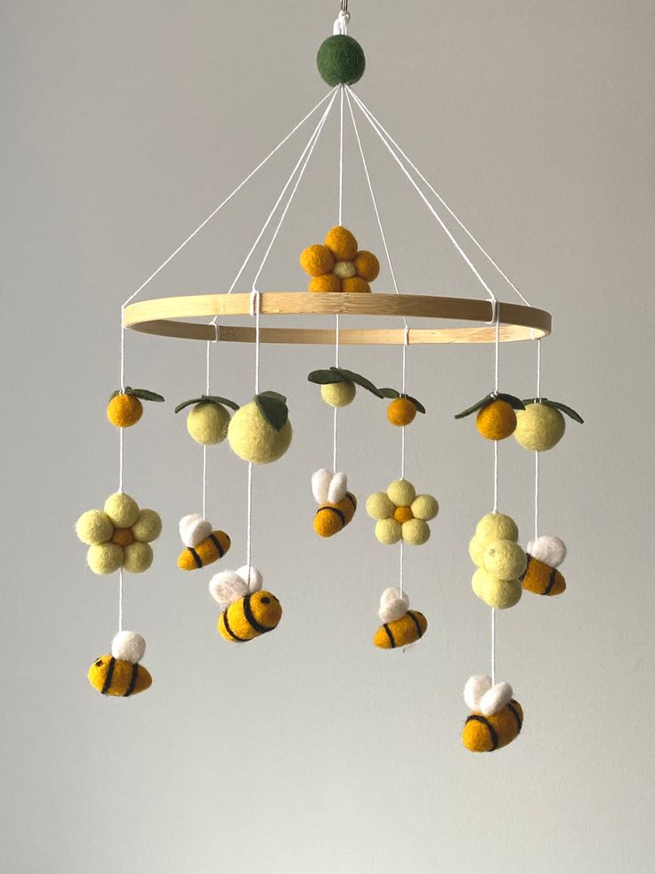 a yellow and white mobile hanging from a ceiling