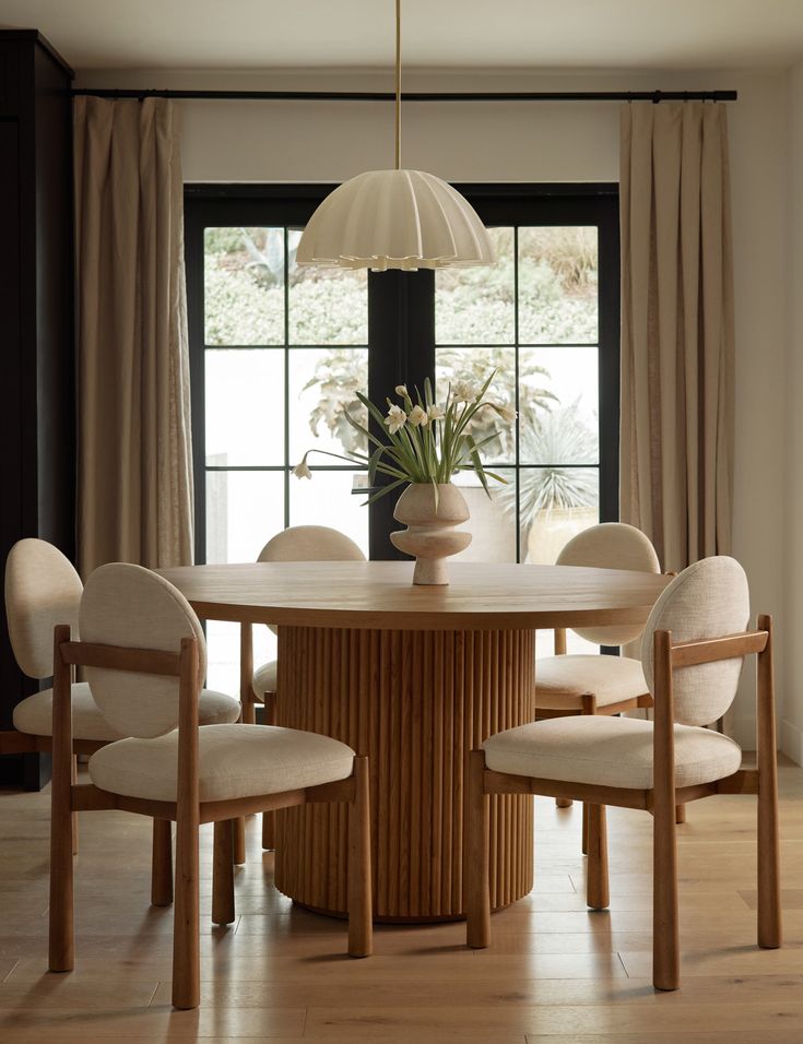 a dining room table with four chairs around it