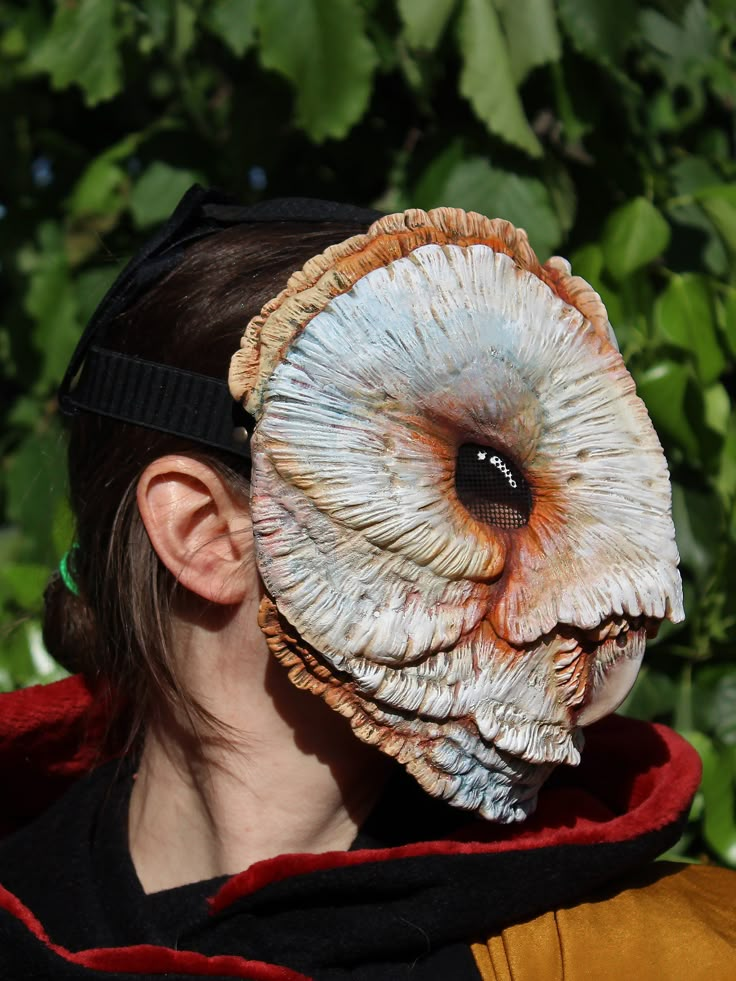 a woman wearing a mask with an animal's eye