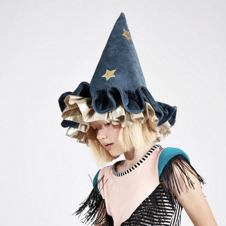 This witch's/wizard's hat, with ruffle details, is very stylish indeed. It is crafted from blue velvet, with gold lamé and gold glitter stars and moons. An essential accessory for Halloween, or to add to a dressing up box for imaginative play any time of the year. The hat is made from soft blue velvet It has ruffle details on the brim made from blue velvet and shiny gold lamé It has a blue velvet elastic strap with a hook and loop fastener Gold glitter stars and moons add a delightful embellishm Witchy Winter Party Costume Hats And Headpieces, Witchy Winter Hats For Party, Witchy Wide Brim Costume Hat For Party, Blue Whimsical Costume Hats And Headpieces, Whimsical Blue Costume Hats And Headpieces For Festival, Blue Halloween Costume Hats And Headpieces, Witchy Style Mini Hats With Curved Brim For Party, Witchy Mini Hats With Curved Brim For Party, Kirby Gijinka