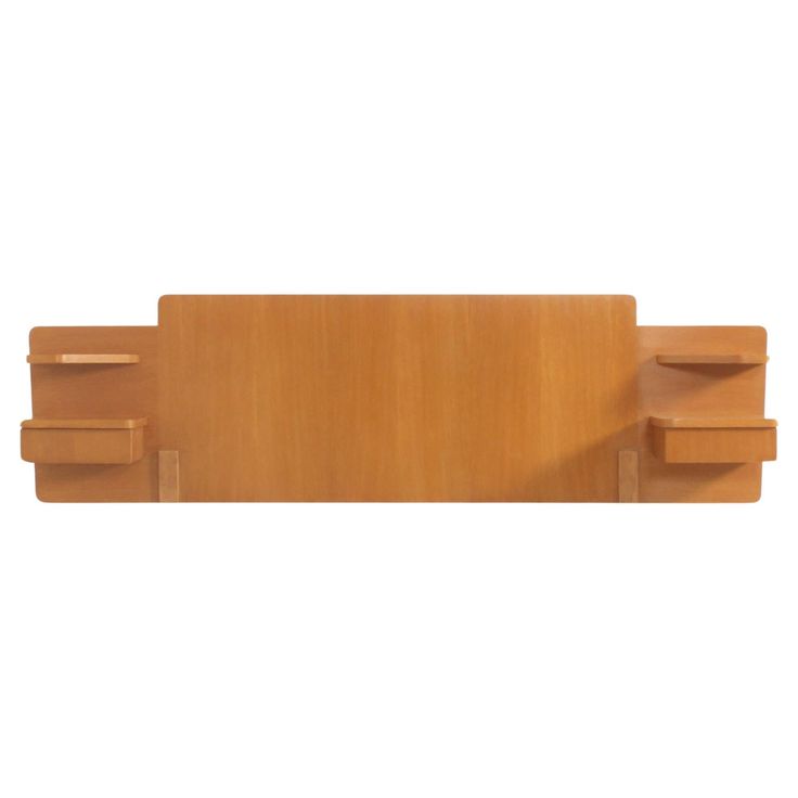 a wooden shelf sitting on top of a white wall