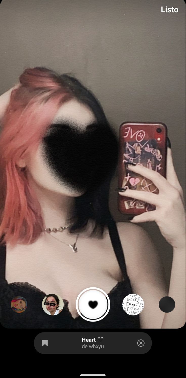 a woman with pink hair is taking a selfie