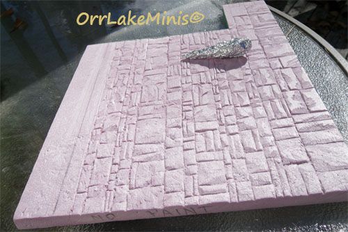 a piece of pink stone sitting on top of a glass table