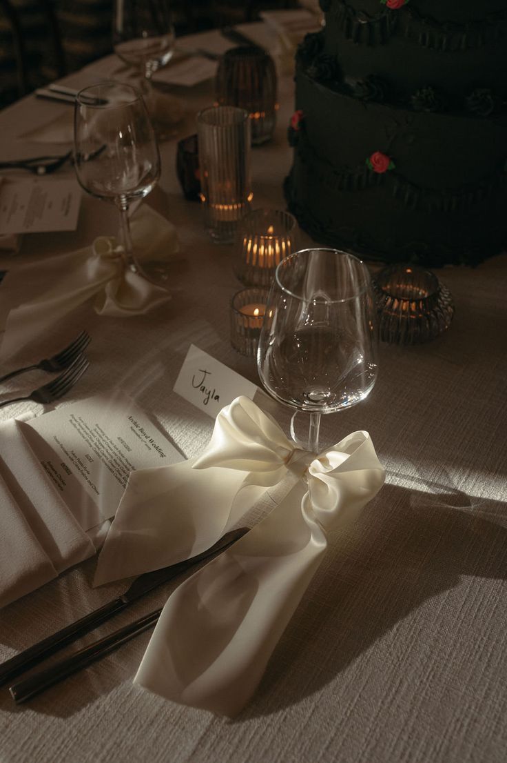 the table is set with wine glasses, napkins and place settings for an event