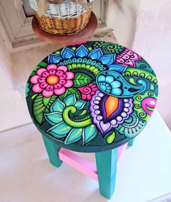 a painted stool sitting on top of a white counter