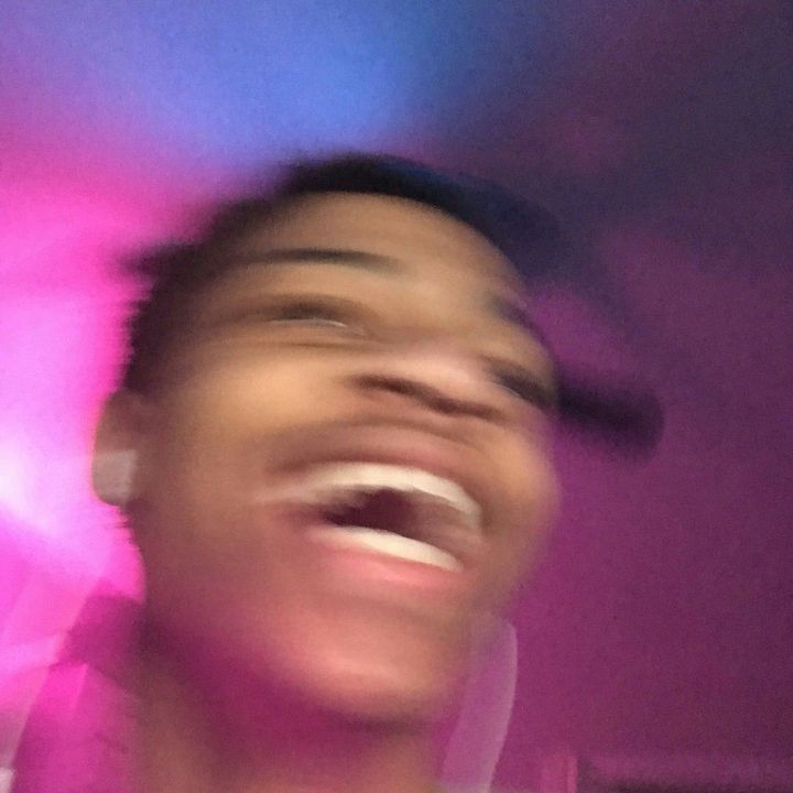 a blurry photo of a man laughing