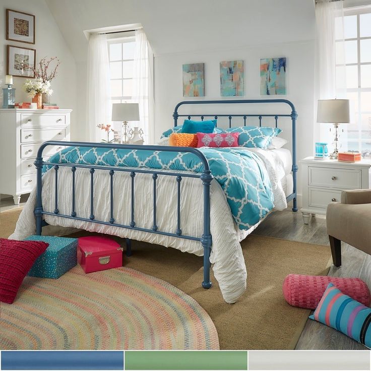 a bed room with a neatly made bed and colorful pillows on the pillowcases