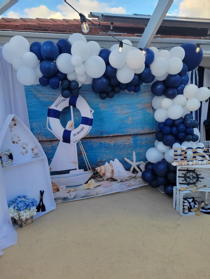 a blue and white party setup with balloons