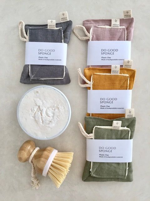 four small pouches with different types of powder in them, one containing a bamboo brush and the other containing an oatmeal