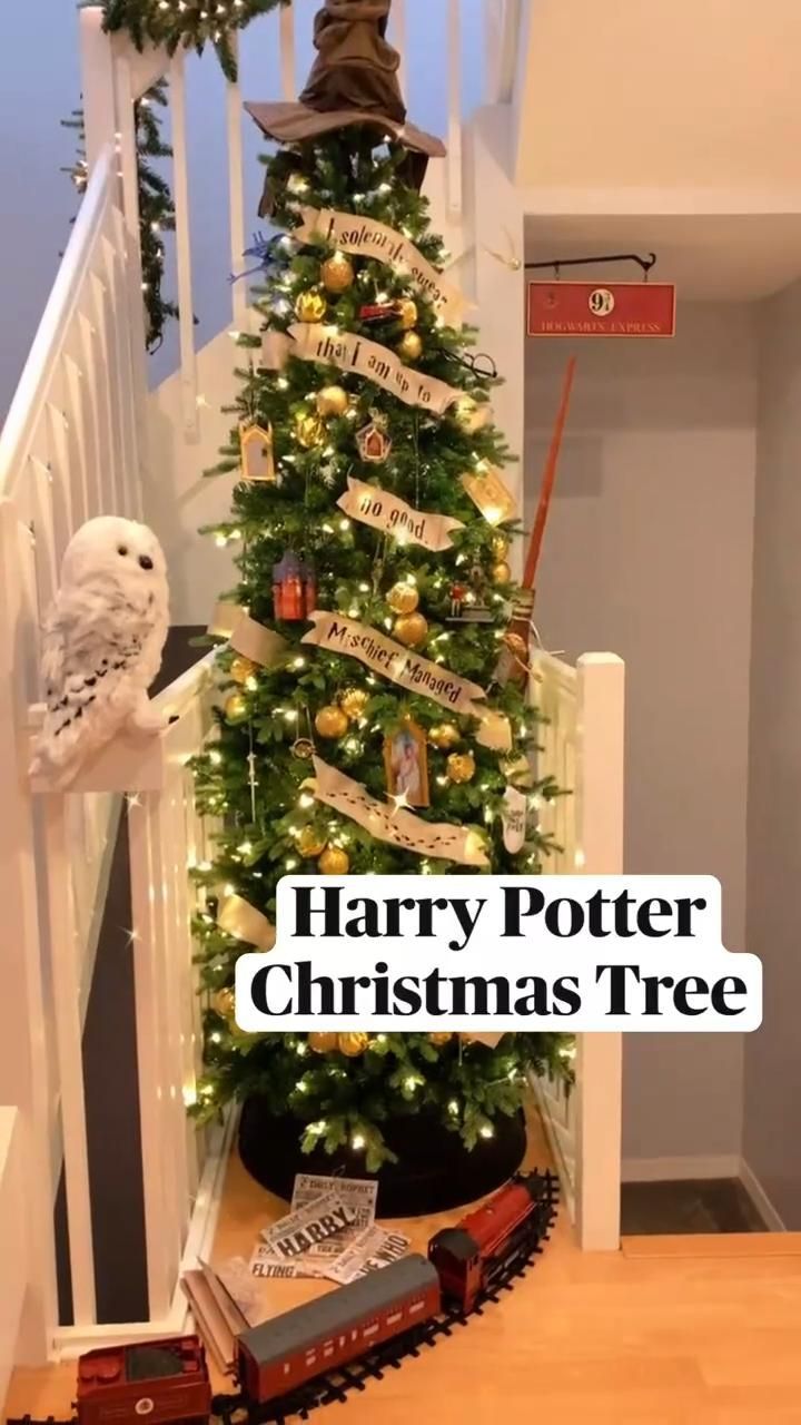 a harry potter christmas tree with hogwarts on top and train around the base