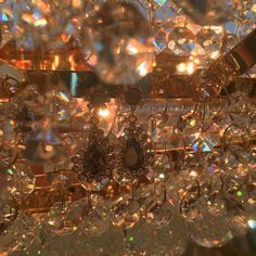 a chandelier with lots of crystal beads hanging from it's centerpiece