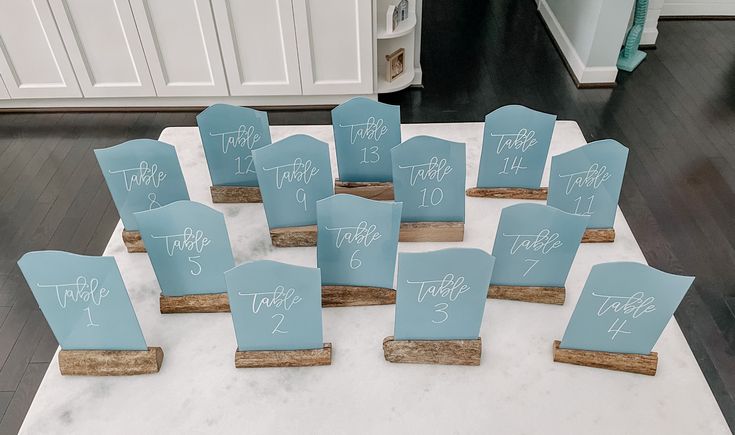 there are many chairs that have been set up on the table for guests to sign