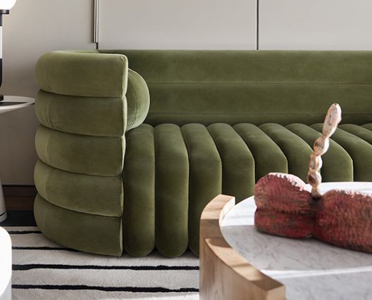 a living room with a green couch and coffee table