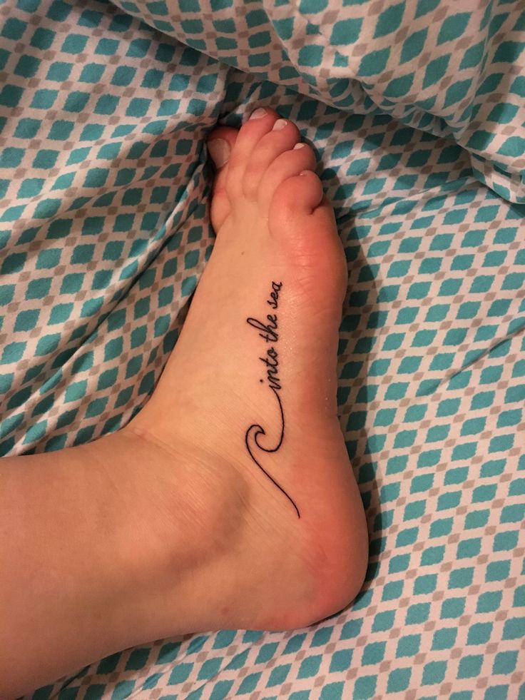 a person's foot with a tattoo on it