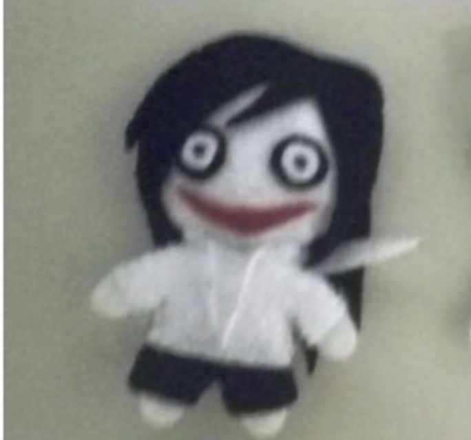 two stuffed dolls one with black hair and the other white