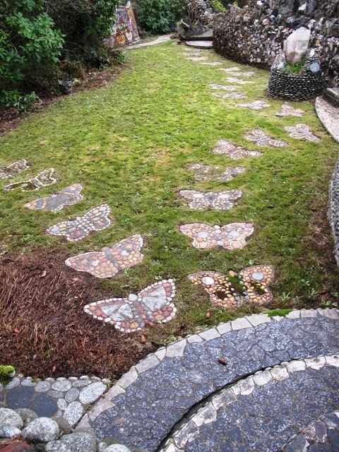 an outdoor garden with stepping stones and grass