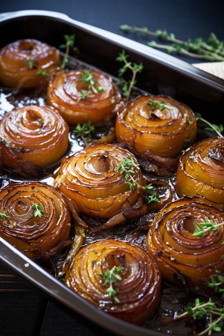 some onion rings are in a pan on a table with parsley and seasoning