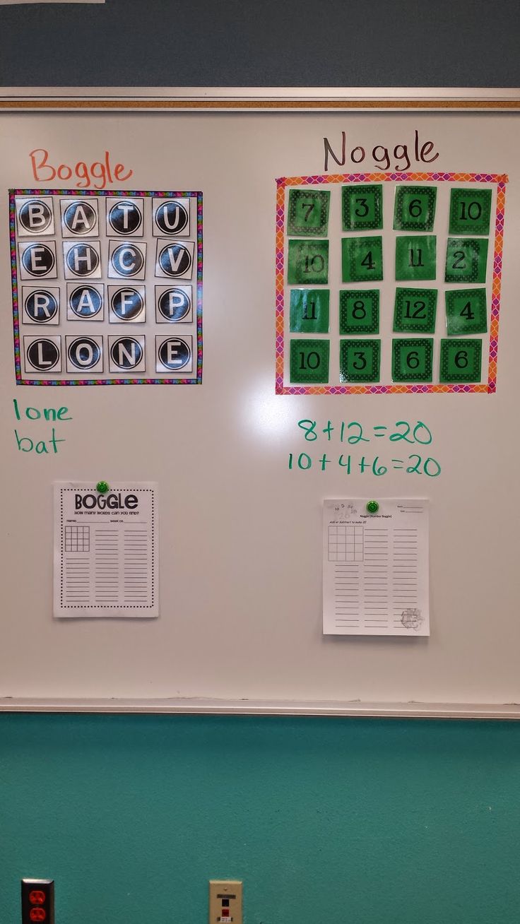 a white board with magnets and numbers on it in front of a blue wall