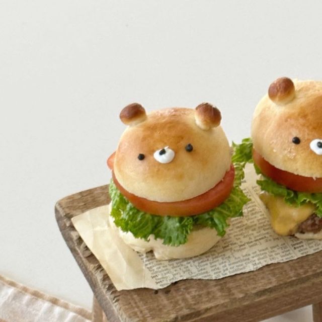 two hamburgers with eyes on them sitting on a table