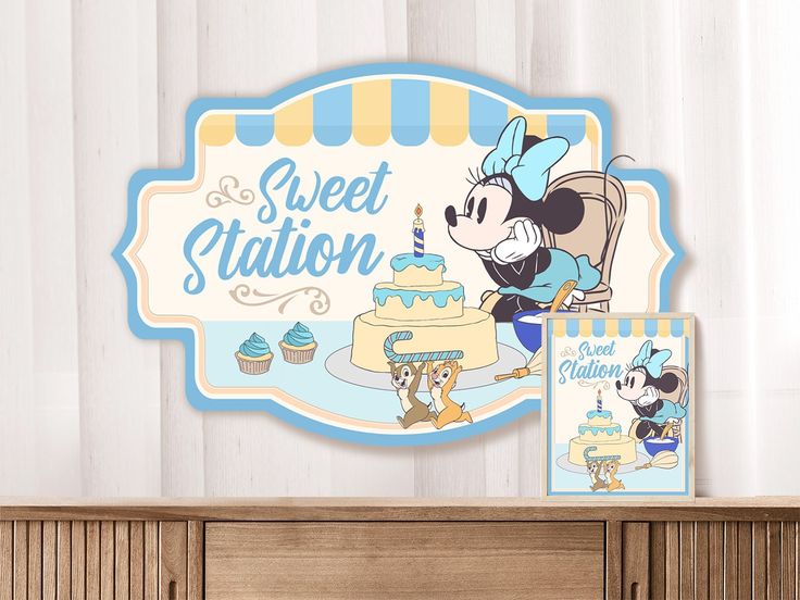 there is a sign that says sweet station with a mickey mouse on it and a cake