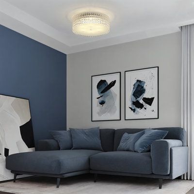 a living room with blue walls and grey furniture