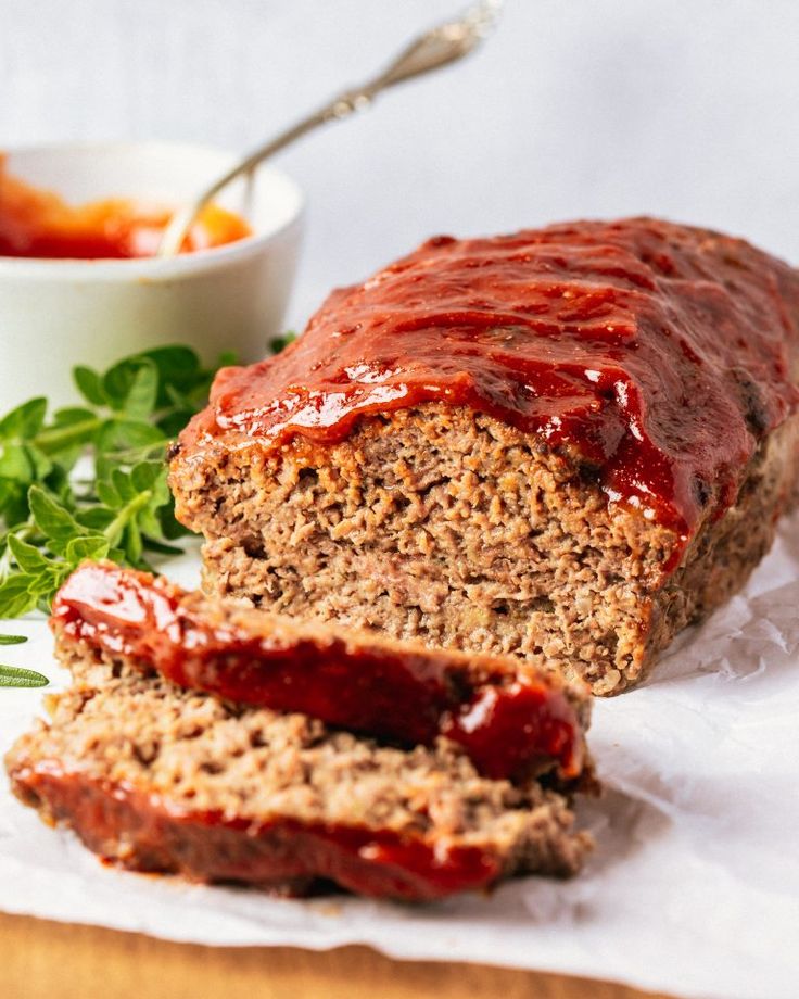 two slices of meatloaf on a white plate