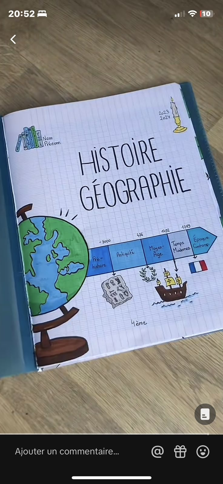 an open book on a wooden table with the title'history of geographie '