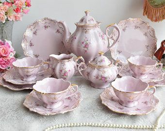 a table topped with lots of pink china