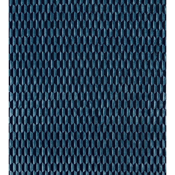 an up close view of a blue fabric textured with rows of small circles on it