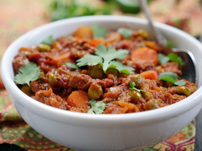 a white bowl filled with food and garnished with cilantro