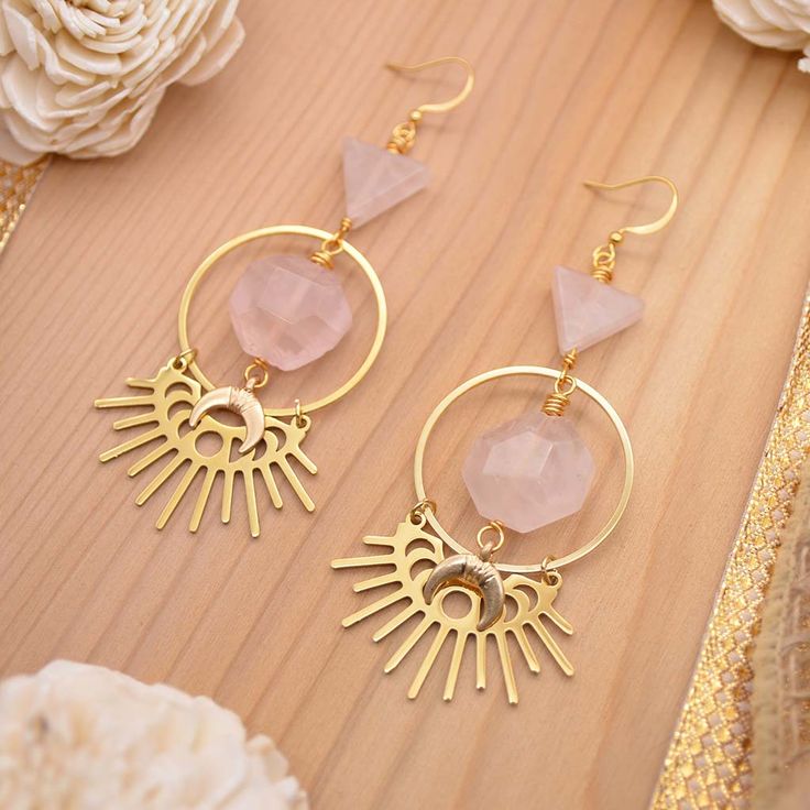 Every now and then you need a little Rose Quartz in your life. ;) Talk about the perfect statement earrings! These babies sparkle with every move you make. Gleaming with gold and the perfect shade of pink that can only be created by natural rose quartz gemstones. Attract tons of compliments with our gorgeous Eclipse of the Heart Earrings handmade with faceted, hexagon rose quartz gems, rose quartz triangles, and 18k gold plated moon burst eclipse charms. Experience a little bit of passion with e Pink Heart Gemstone Earrings, Pink Heart-shaped Gemstone Earrings, Pink Rose Quartz Jewelry For Party, Pink Rose Quartz Party Jewelry, Pink Rose Quartz Jewelry With Matching Earrings, Gold Rose Quartz Jewelry For Jewelry Making, Pink Rose Quartz Drop Earrings, Pink Rose Quartz Earrings For Gifts, Pink Rose Quartz Earrings Gift