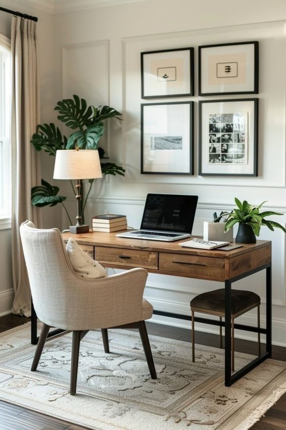 a laptop computer sitting on top of a wooden desk next to a chair and potted plant