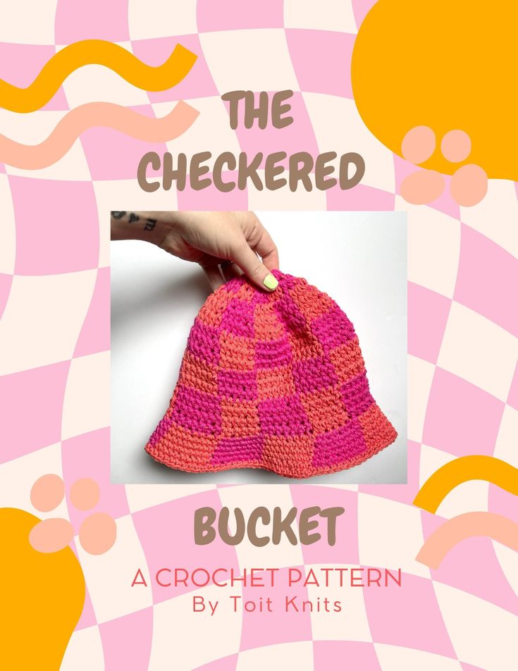 a crocheted hat with the words, the checked bucket written in pink and orange